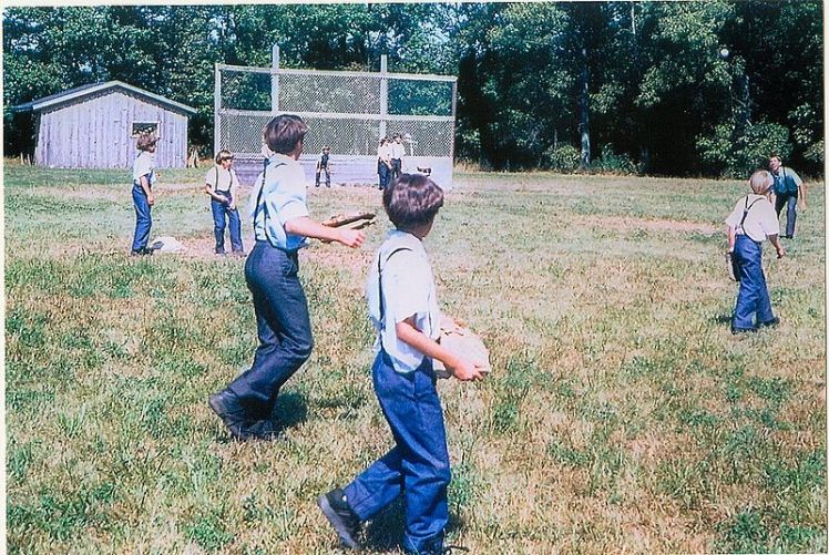 Amish children playing baseball