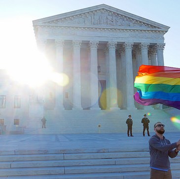 Rainbow flag waving before Supreme Court in April 2015