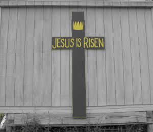 Wooden cross inscribed, "Jesus is Risen"