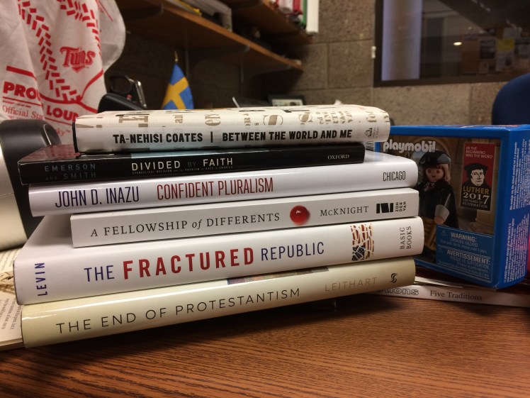 Stack of books by Michael Emerson, John Inazu, Scot McKnight, et al. on unity and division