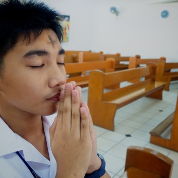 Man praying, with ashes