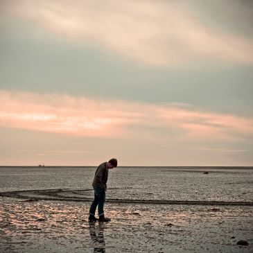 Image of man alone on a beach