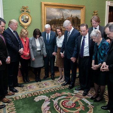 Donald Trump praying with others