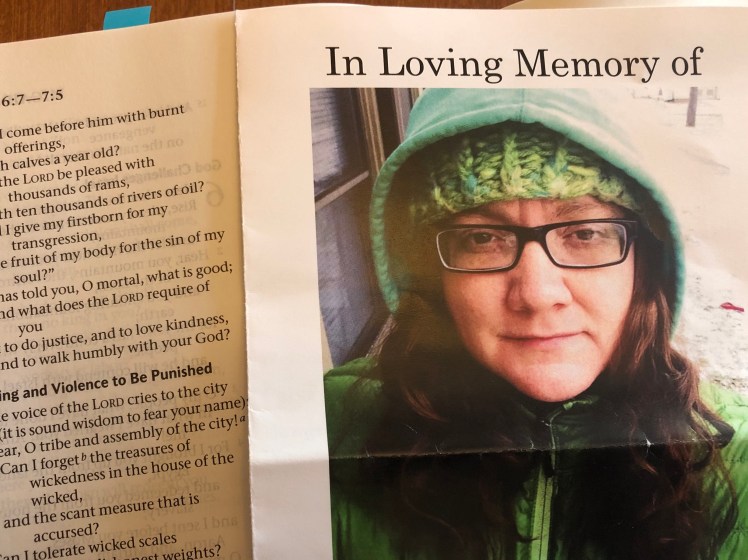 Program from Kim Weaver Olson's memorial service, with a Bible opened to Micah 6:8